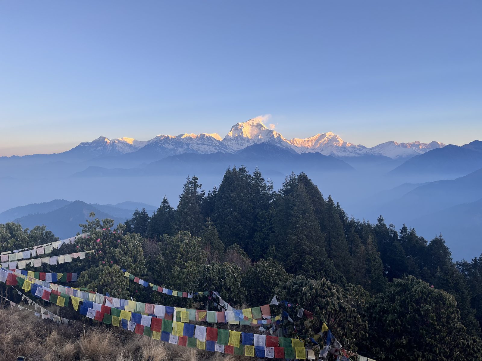 Prayer flags along a ridge above the Annapurna range at first light