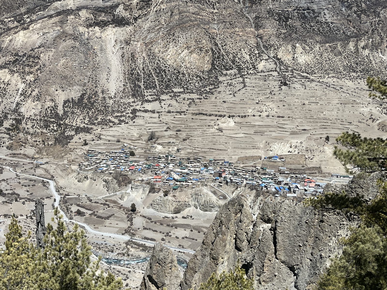 Aerial view of Manang village among eroded cliffs