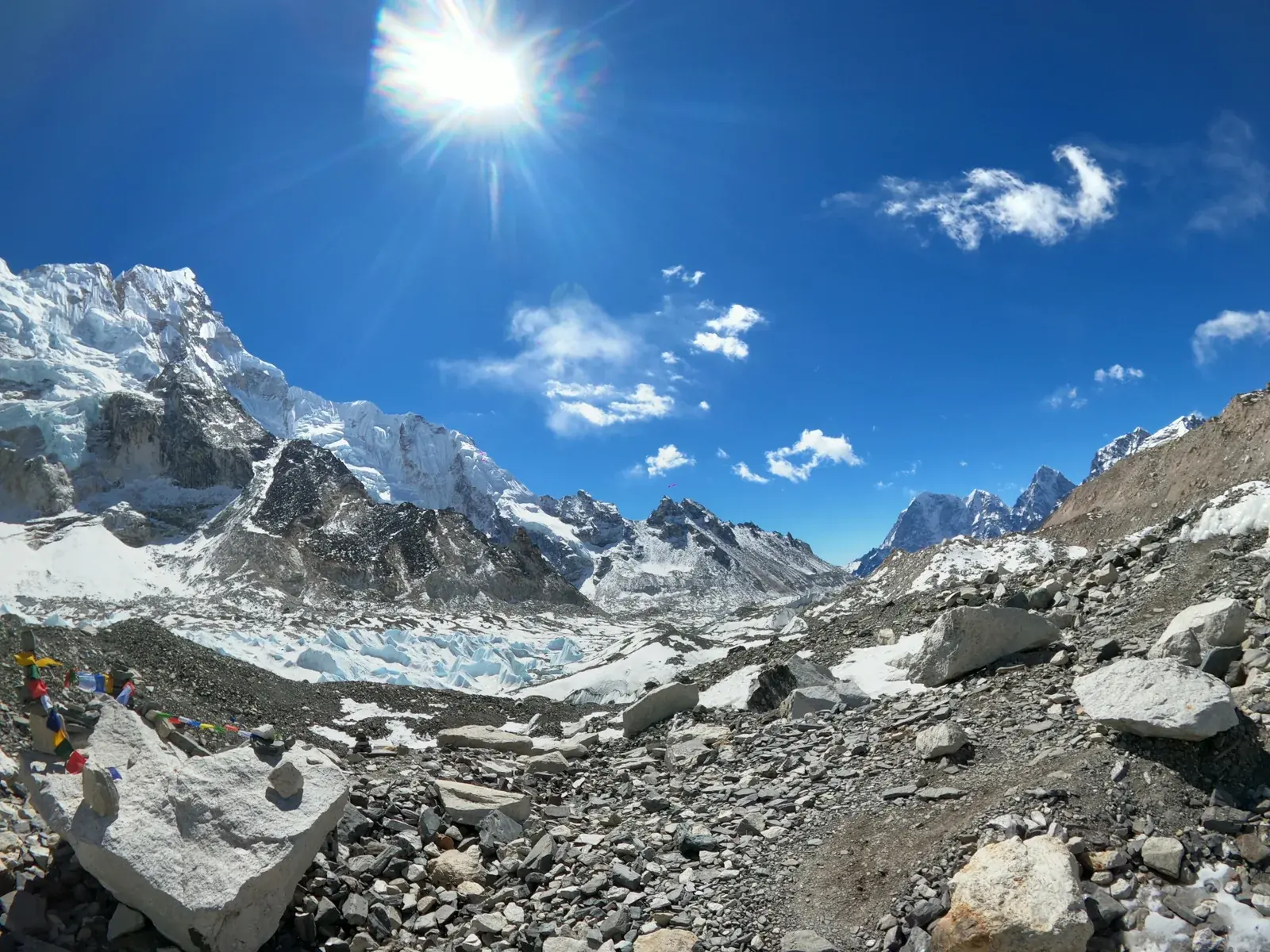 Trekkers on the rock and ice of the Khumbu glacier