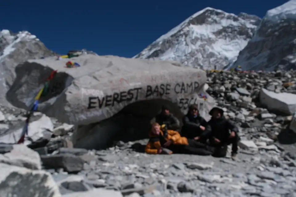 The painted Everest Base Camp marker rock at 5,364m with trekkers