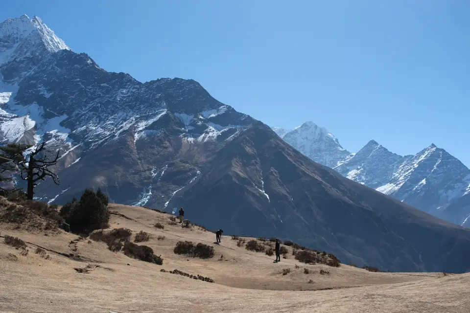 A wide trail through the Khumbu valley below snow-capped peaks
