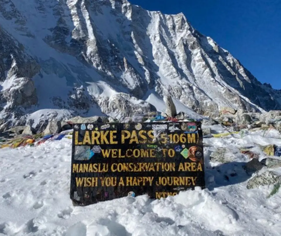 The Larke Pass 5,106m welcome sign in the snow