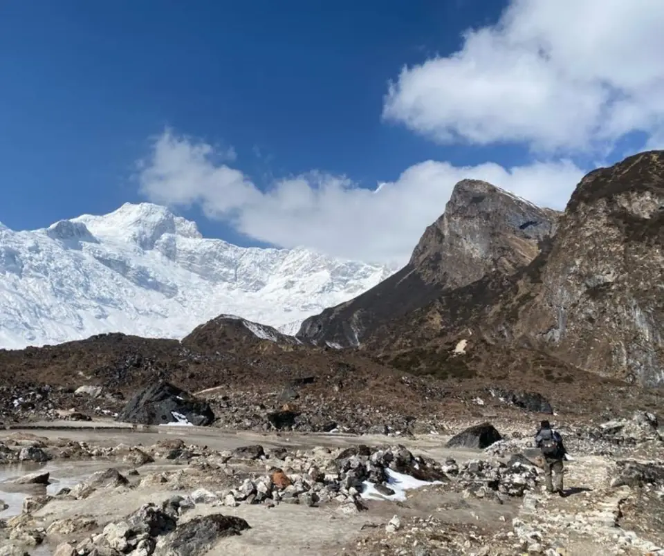 A rocky moraine trail winding beneath the peaks